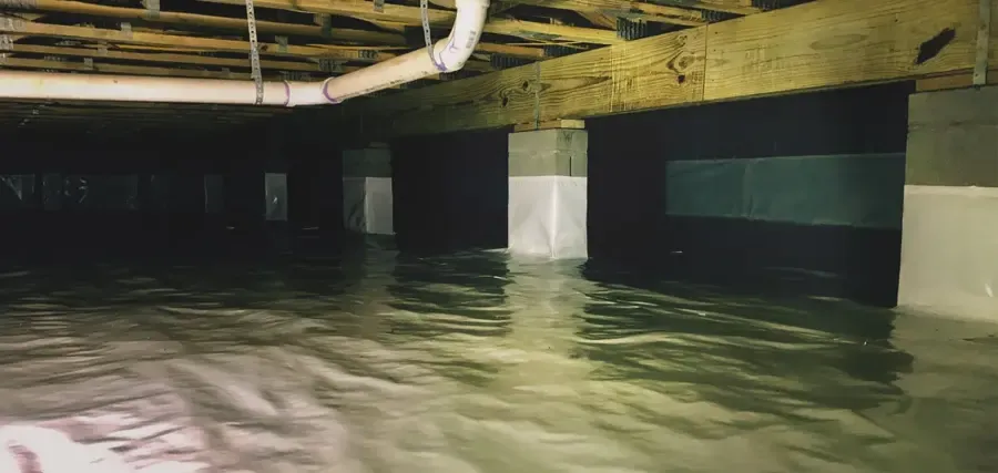 Standing water in a crawl space under an Alpharetta, GA home