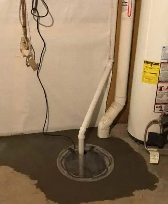 A failed sump pump in a flooded Alpharetta, GA basement pit